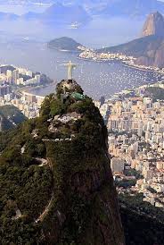 Rio De Janeiro Christ The Redeemer Cristo Redentor Looking Over The City With Sugarloaf Mountain Pao De Acuc American Vacations Dream Vacations Places To Go