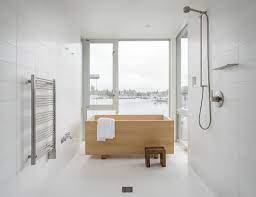Incorporating a few dark accents and a soft transition color (like the pale gray in the shower) is a good way to add some dimension to the bathroom. 10 Minimalist Bathrooms Of Our Dreams