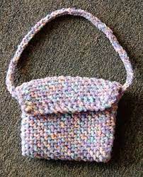 Free tutorial with pictures on how to stitch a knit or crochet pouch in under 90 minutes by knitting with scissors, knitting needles, and worsted weight yarn. Knit Bag Pattern Done On Bias Knitting Bag Pattern Knitted Bags Barbie Knitting Patterns