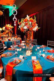 A pumpkin orange is perfect for a fall wedding, whether you want it as your main color for bridesmaids dresses or as an accent. Michael Daigian Design Orange Decor Teal Orange Weddings Orange Wedding