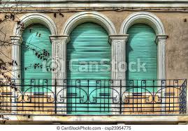 Of all the types of window blinds available today, roller blinds have probably undergone the most significant and noticeable renaissance in terms of design style. Three Green Roller Blinds In An Old Italian Balcony Processed For Hdr Tone Mapping Effect Canstock