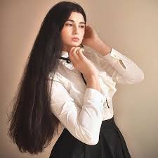 Slender, with platform shoes and long, feathered hair. Verylonghair
