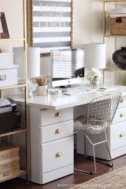 Black and gold home office features walls painted bold black lined with a gold capiz mirror over a black french desk adorned with gold ring pulls, shared by two, lined with ivory square back french chairs alongside a gold abstract art piece. Office Plans Changes White Office Decor Home Office Decor Gold Office Decor