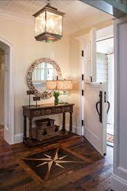 In the entry hall of a mercer island, washington home designed by kelly wearstler, the light fixture a collection of portraits covers an entry wall at jeweler and retailer federico de vera's weekend retreat. Entry Hall Entry Hall Design Ideas An Inlaid Compass Rose Sets A Nautical Note In The Entry Hall According To The Des Cottage Entryway Foyer Decor Entryway