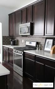 Inspired by the clients ideas and preferences this transitional kitchen remodel is packed with custom features. The Yellow Cape Cod Dark Tile Light Grout Kitchen Backsplash Home Kitchens Kitchen Renovation Kitchen Remodel