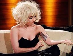 The right thigh of the musician has a tattoo of a gun on it. Lady Gaga S 24 Tattoos Their Meanings Body Art Guru