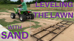 Run a straight board over the pipes to screed off any excess sand. Top Dressing And Leveling With Sand For A Flat Lawn Youtube