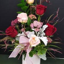 Cast armrest on a bench near blue hydrangeas bush. Cypress Florist Flower Delivery By Classics Flowers And Confections