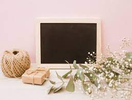 Download Blank Wooden Slate With Spool Gift Box And Baby S Breath Flowers On Wooden Desk Against Pink Background For Free Flower Background Wallpaper Photo Frame Design Pink Background