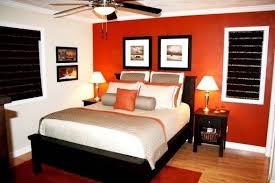 Crafty orange living room with orange walls, cozy orange sofa, chic upholstered orange armchairs, a fireplace, and antique decor pieces. Bedroom Ideas Orange And Brown Bedroom Orange Orange Bedroom Decor Bedroom Colors