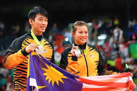 Goh liu ying (left) hits a shot next to chan peng soon in their mixed doubles badminton group stage match against germany's mark lamsfuss and germany's isabel herttrich during the tokyo 2020 olympic games at the musashino forest sports plaza in tokyo on july 25, 2021. The Story Of Goh Liu Ying S Courageous Journey To The Olympics