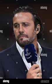 Milan, Italy, 19th April 2023. Former striker Luca Toni reacts as he holds  a UEFA Champions League and Amazon Prime branded microphone as he comments  following the UEFA Champions League match at