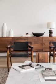 The Clean White Interior Is Enriched With Rich Colored Wood And Touches Of Black Japandi Minimalist Living Room Decor Furniture Design Modern Furniture Design