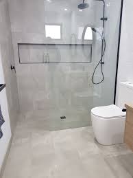 With bathroom requirements staying the same and the space shrinking, bathroom designs need to be more ingenious and efficient. Black Framed Shower Niche Bathroom Design Small Bathroom Design Bathroom Interior