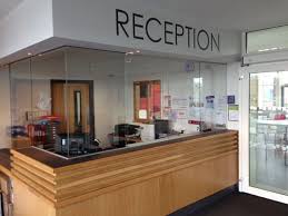 Help with glass partitioning options. Reception Medical Office Decor Reception Desk Design Reception Desk Office