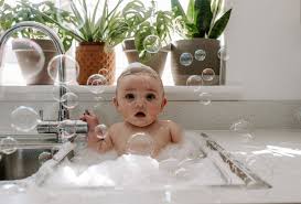 You can gently splash or pour warm water over your baby to keep them warm in the tub. Baby Boy In 2021 Baby Boy Photography Baby Milk Bath Newborn Photography Boy