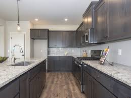 The Fairview Kitchen Is Finished With Granite Counter Tops Tile Back Splash Ge Stainless Steel Appliances Kitchen Cabinet Design Home New Homes