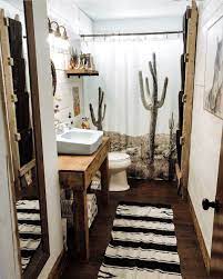 A wall gallery of favorite objects like starfish or baskets can be a personal and refreshing way to decorate your bathroom walls. Save A Room In Your Home For This Southwestern Style Bathroom Cowgirl Magazine Bathroom Bathroom Decor Apartment Western Bathroom Decor Brown Bathroom Decor