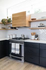 Mid Century Modern Home With Black Cabinets White Countertops White Scallop Backsplash Modern Black Kitchen Mid Century Modern Kitchen Modern Kitchen Design