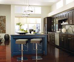 If you are looking for a modern coastal kitchen, our colonial naval cabinets with a waterfall island are a great choice! Dark Wood Cabinets With A Blue Kitchen Island Omega