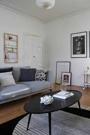 See more ideas about living room designs, living room decor, home living room. Scandinavian Style Living Room With Grey Sofa Black Coffee Table White Walls And A Warm Oa Living Room Grey White Furniture Living Room Grey Sofa Living Room