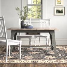 The solid grey stained oak table has a curvaceous base. Farmhouse Rustic Grey Dining Tables Birch Lane