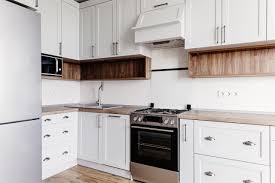 Black knobs and pulls give the bright white cabinets a pop of contrast. Cabinet Hardware Placement Guide For Shaker Cabinets