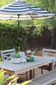 Black And White Striped Outdoor Umbrella With Lights Outdoor Centerpiece With A Coral Cactus Shells Pottery Honey N Hydrangea Patio Table Centerpiece Patio Beautiful Backyards