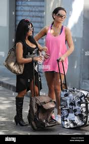 Jenni JWoww Farley and Nicole Snooki Polizzi Jersey Shore cast members  pick up their fresh laundry from the Laundromat with their suitcases.  Florence, Italy - 25.05.11 Stock Photo - Alamy