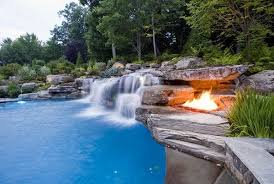 Pool Design With Large Waterfalls And Fire Bowls Pool Garden Swimming Pool Designs Pool Waterfall Pool Landscaping