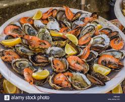 Download This Stock Image Seafood Platter Of Shrimp And Raw Oysters Topped Off With Lemon Sl Easy Seafood Recipes Seafood Bisque Recipe Seafood Recipes Salmon