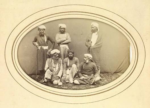 A group of Thuggees (Thugs) Sitting on a Carpet, taken in Peshawar (now in Pakistan) - c1860s - Old Indian Photos
