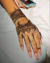 Are Finger Tattoos A Bad Idea In 2021 Hand And Finger Tattoos Cool Wrist Tattoos Rihanna Hand Tattoo