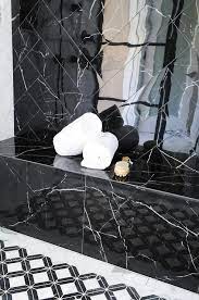Amazing gallery of interior design and decorating ideas of marble shower bench in bathrooms by elite interior designers. Polished Black Marble Shower Tiles In Herringbone Pattern Contemporary Bathroom