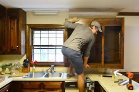 You can get under the uppers and hold them up (it may be easier for some to do it this way). Removing Some Kitchen Cabinets Rehanging One Young House Love
