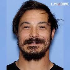 A new wanted poster of Travis Decker shows updated photos of the  triple-murder suspect, including close-ups of his tattoos.