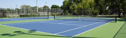 4k00:14an elderly man is training on a tennis court near a tennis backboard hitting wall, time lapse. Tennis City Of Richmond Hill
