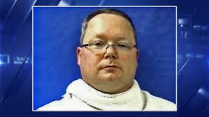 Former official charged in Texas DA slayings