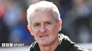 Mark Hughes: Carlisle United boss agrees to stay