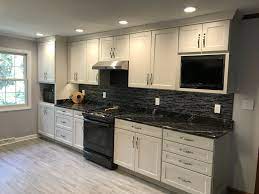 Kitchen Remodel With White Cabinets And Black Counters Black Kitchen Countertops Backsplash Kitchen White Cabinets White Cabinets Black Countertops
