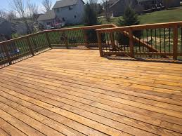 Red brick house, with deck with white railings and composite decking. Most Popular Deck Stain Colors 2021 Best Deck Stain Reviews Ratings