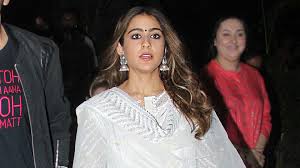 Sara Ali Khan Joins Kartik Aaryan At Mumbai Airport In A White Gota Patti Kurta Set Vogue India Kartik aaryan wears a paul smith shirt with a ss home suede vest. sara ali khan joins kartik aaryan at