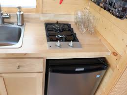 The tiny house kitchen features butcher block counters, soft close cabinets, a 10 cu.ft. Photos That Show The Ugly Truth Of Living In A Tiny House
