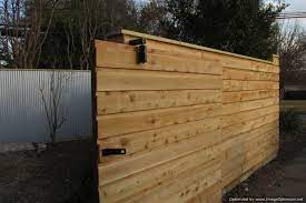 Try to place the nails behind where your vertical battens and horizontal rails will go to reduce the amount of for the cap on our board and batten wall we decided to use outside corner moulding, adhered with construction. Board On Batten Horizontal Fence Half Lap Wood Framed Slider Gate Backyard Fences Rustic Fence Front Yard Fence