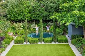 How One Couple Turned A Rancid Basement Into A Spacious Family Home Worth Three Times Their Investment Trampoline Garden Garden Trampoline Family Garden
