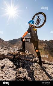 The well-known alpine unicyclist Michael Rung in the Karwendel mountains at  over 2300 m height with his unicycle. In the background the Great Seekarsp  Stock Photo