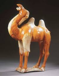« photo précédente | photo suivante ». An Amber And Straw Glazed Red Pottery Figure Of A Bactrian Camel