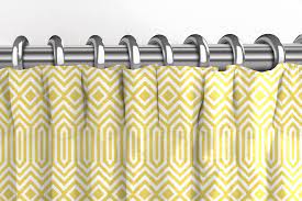 Decorative metal eyelets are sewn into the top of the curtain fabric so there is no need for curtain rings or hooks. Mcalister Textiles Geometric Patterned Yellow Curtains