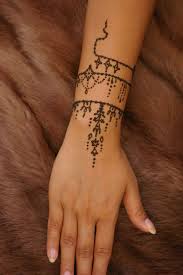 Faux Fur Surface Under An Arn Decorated With A Small Henna Tattoo In Dark Brown Decorated With Flourishes And A Win In 2020 Arm Band Tattoo Henna Tattoo Sleeve Tattoos