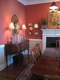 A more casual dining room chair rail with a flat profile mimics the board and batten used in this families' eclectic room. Love This Color Wallpaper Below Chair Rail Red Dining Room Dining Room Wall Color Dining Room Colors